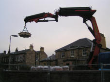 Part of one of the crown tops being lifted into the garden.