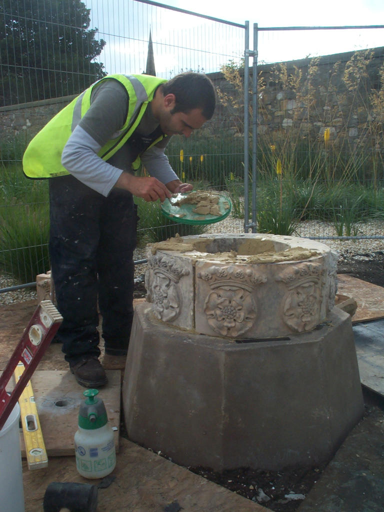 A conservator working on one of the smaller pillars